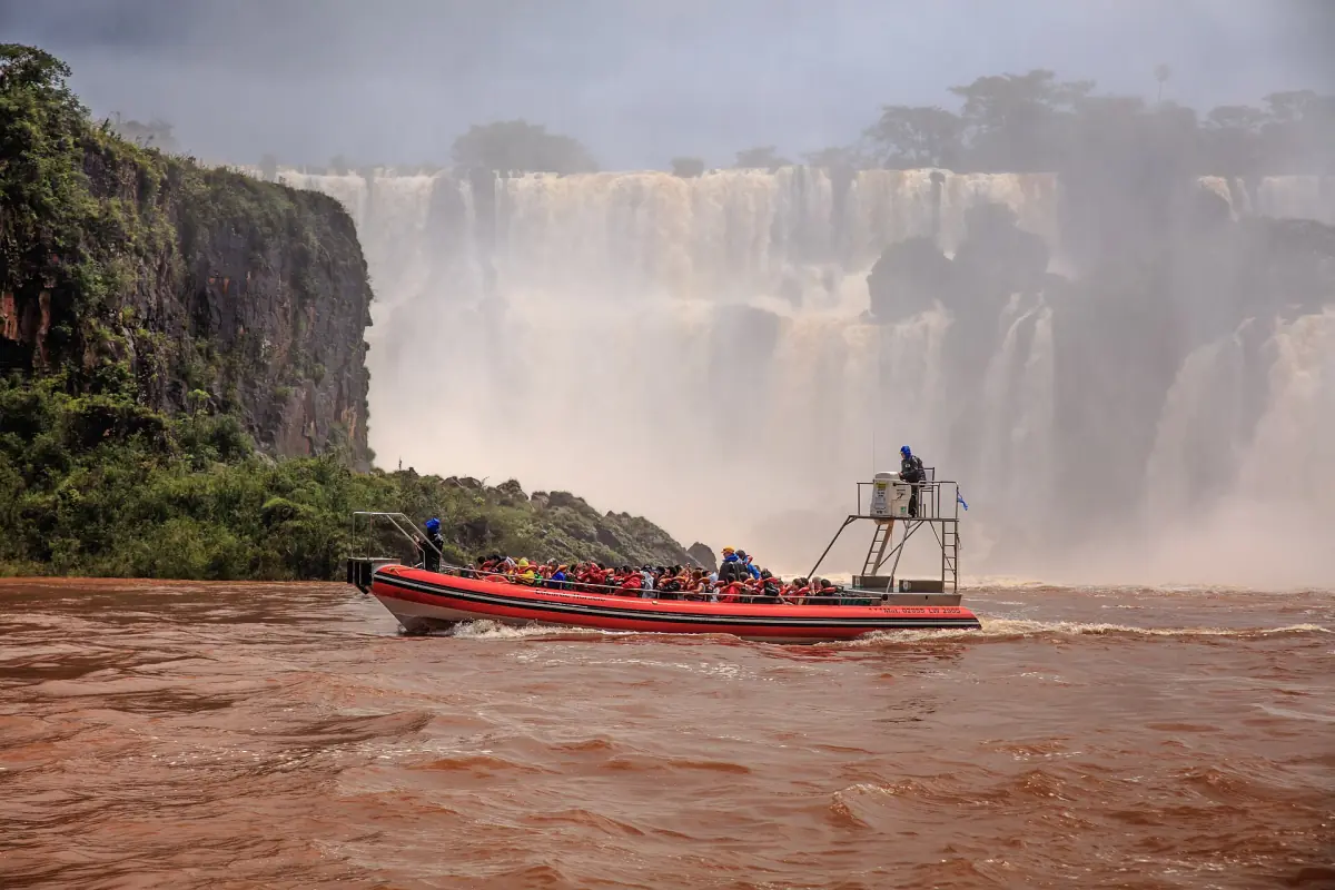 A speedboat heading toward the foot of the falls
